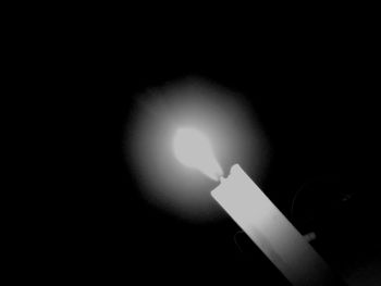 Close-up of illuminated lamp in darkroom