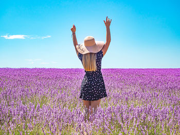 Close up of a young girl with a hat on her head between lavender in southern provence valensole 