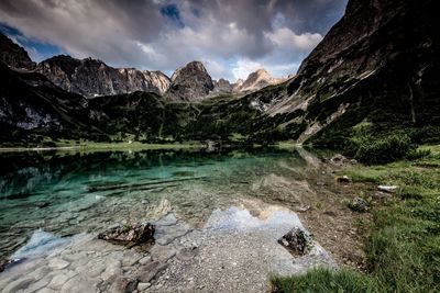 Scenic view of lake against cloudy sky