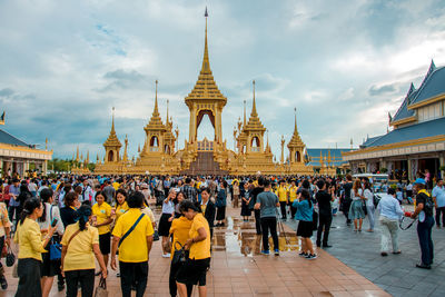 People at temple against sky