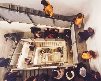 High angle view of people walking on spiral staircase