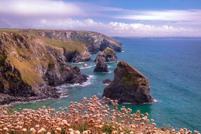 Scenic view of sea and rock formation against sky