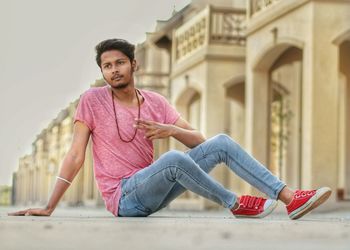 Full length of man sitting on road