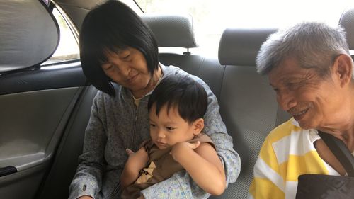 Family sitting in car