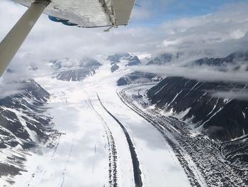 Aerial view of snowcapped mountains against sky