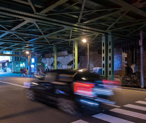 Cars on illuminated street at night