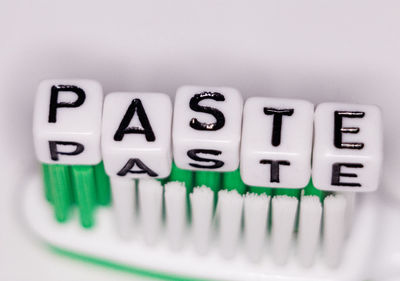 Close-up of toothbrush with alphabet blocks on table