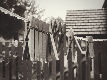 Close-up of wet clothespins on rope during rainy season