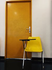 Empty chairs and table in building