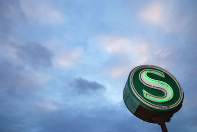 Low angle view of road sign against sky