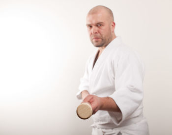 Portrait of a man standing against white background