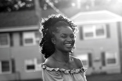 Portrait of laughing young woman outdoors