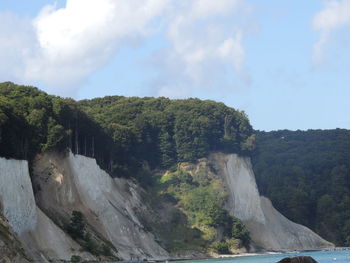 Scenic view of waterfall against sky