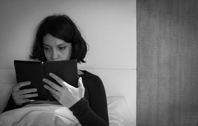 Young woman using digital tablet at home