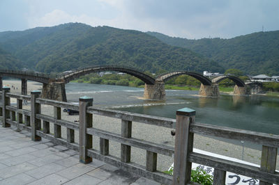 Bridge over mountains against sky