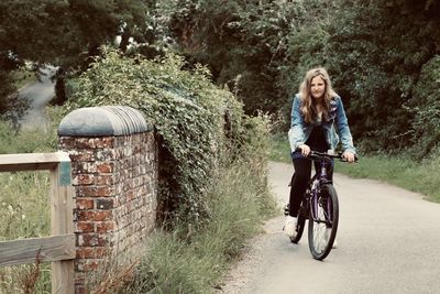 Full length of woman riding bicycle