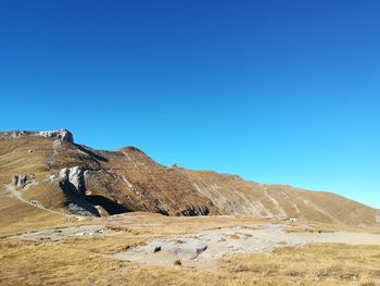 Scenic view of rocky mountains against clear blue sky