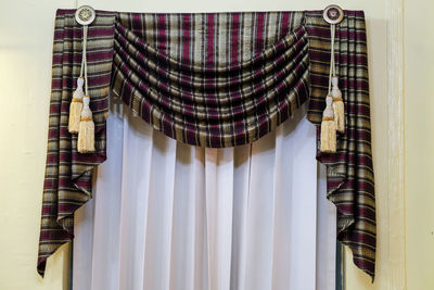 Close-up of clothes standing against white wall