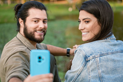 Portrait of young woman using mobile phone