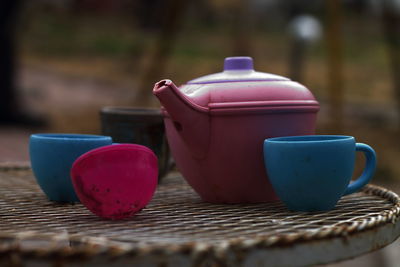 Close-up of old toy tea set on table