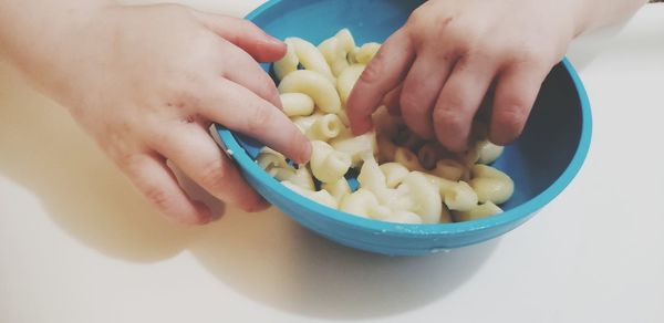 Midsection of woman preparing food in bowl on table