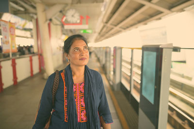 Portrait of woman standing in bus