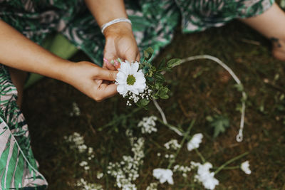 Midsection of woman holding flowers