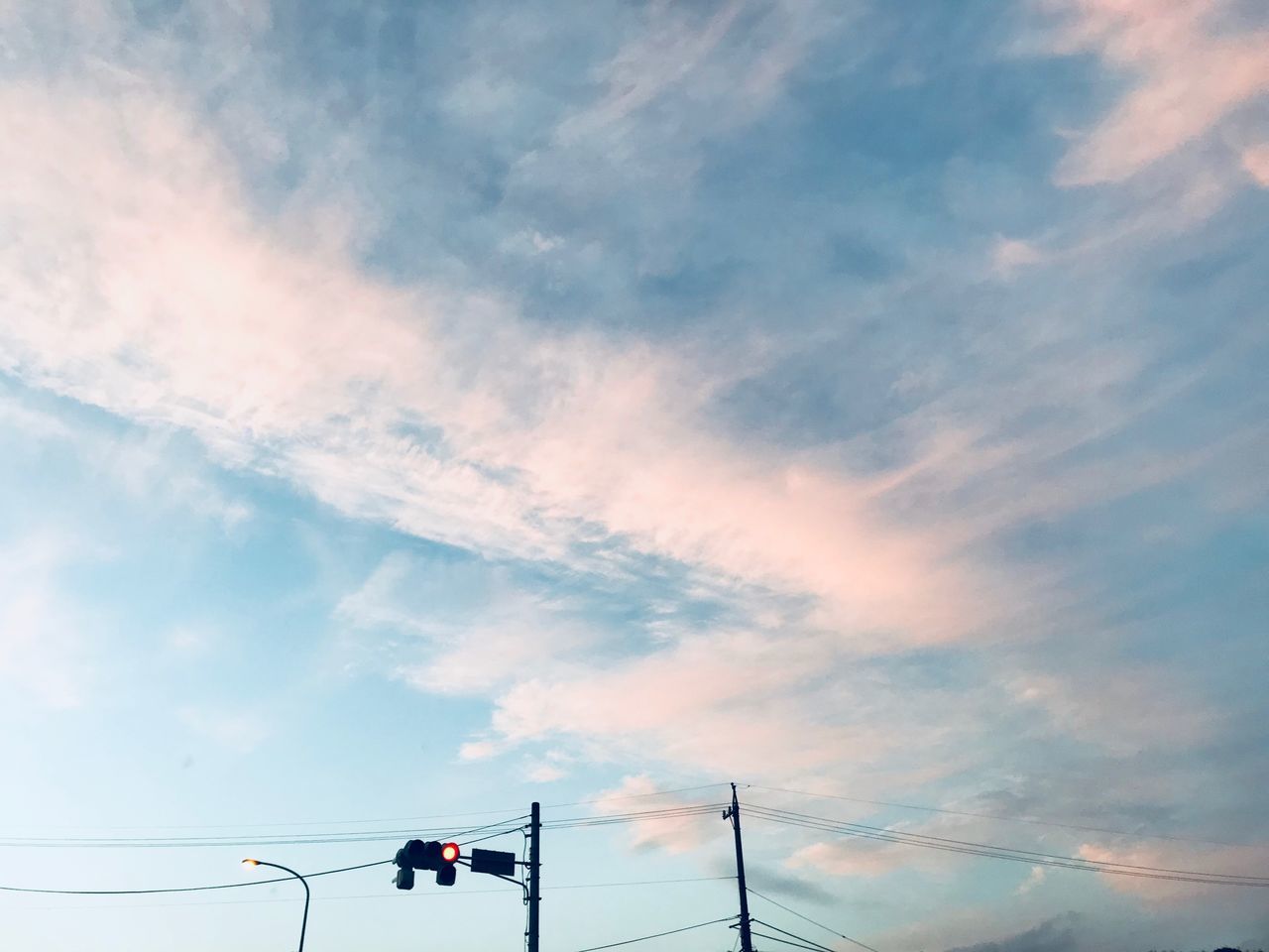 cloud - sky, sky, low angle view, nature, electricity, no people, outdoors, day, sunset, lighting equipment, signal, technology, power line, connection, light, red light, cable, beauty in nature, street, pole, power supply