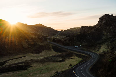 Sunset sky over mountains and road in nature