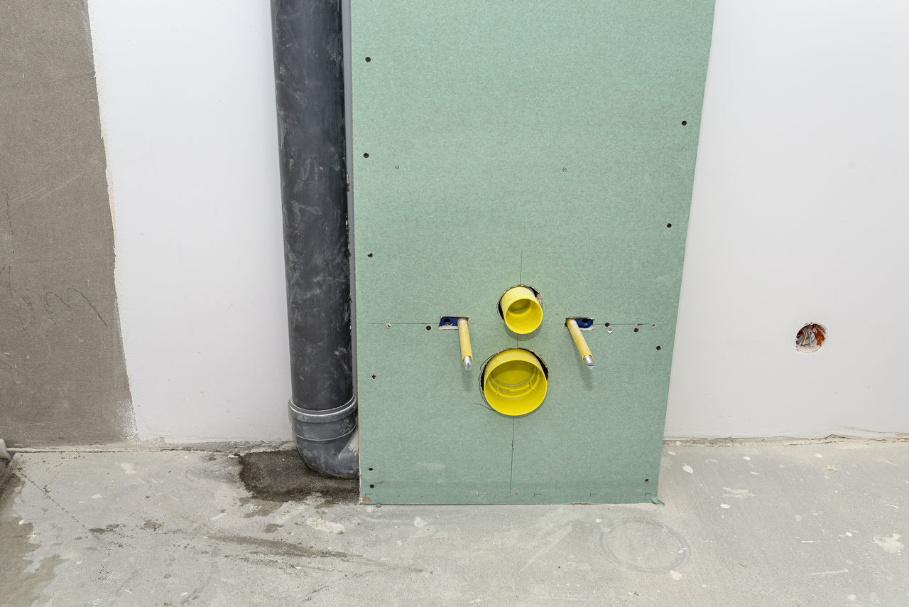 HIGH ANGLE VIEW OF YELLOW METAL DOOR WITH WALL