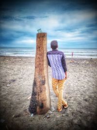 Rear view of woman standing on beach
