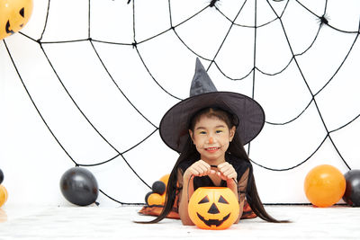 Portrait of cute boy against sky during halloween