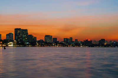 Illuminated city at waterfront