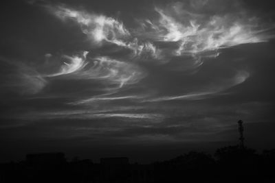 Low angle view of silhouette trees against sky