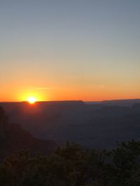 Scenic view of mountains against clear sky during sunset