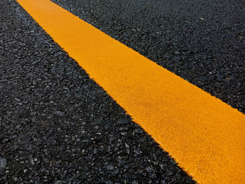 High angle view of yellow line on asphalt