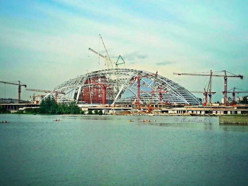 built structure, architecture, connection, sky, building exterior, water, transportation, waterfront, blue, river, day, low angle view, outdoors, nautical vessel, bridge - man made structure, cloud - sky, no people, power line, ferris wheel, cloud