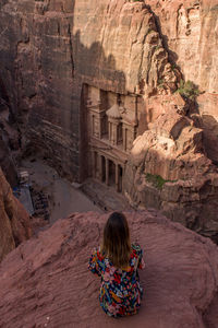 Rear view of woman on rock