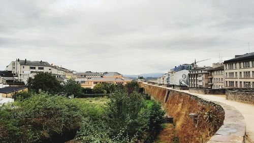 High angle view of buildings and trees against sky