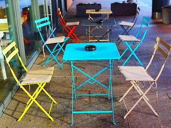 High angle view of chairs and tables at sidewalk cafe