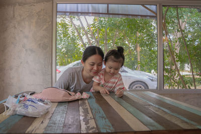Women sitting on table by window