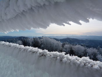 Scenic view of snow covered mountains against sky