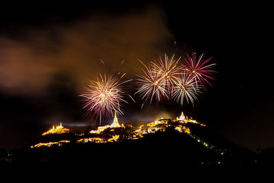 Low angle view of firework display at night