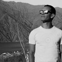 Portrait of young man wearing sunglasses standing outdoors