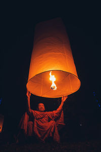 Illuminated lantern at night