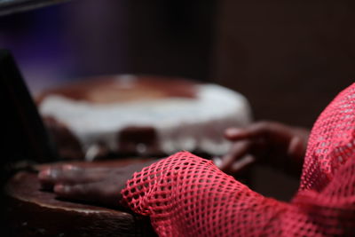 Close-up of woman sitting on table