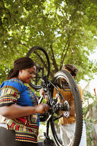 Low angle view of woman riding bicycle