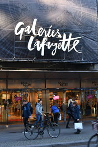 Group of people walking in front of restaurant