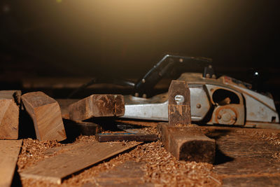 Close-up of a carpenter using a circular saw or a tool to cut wooden planks to make furniture  