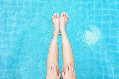 Low section of woman in swimming pool